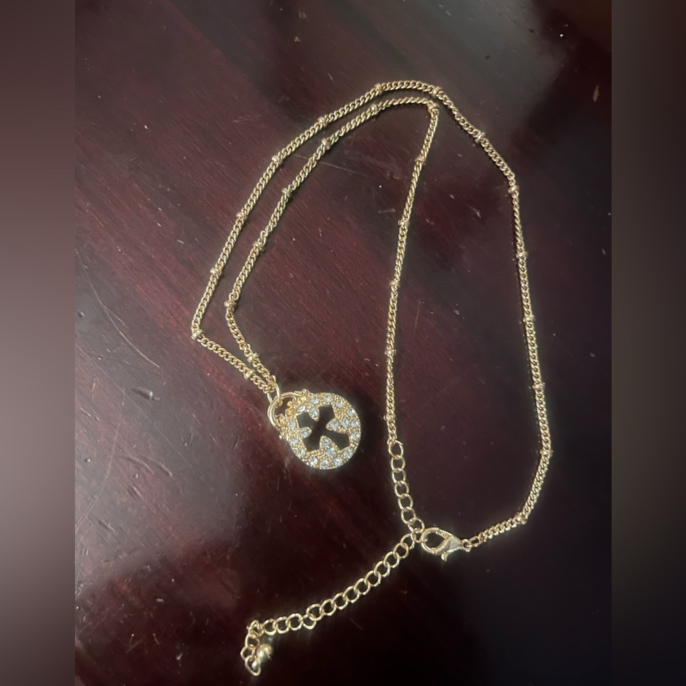 Gold tone cross necklace with blingy crystals